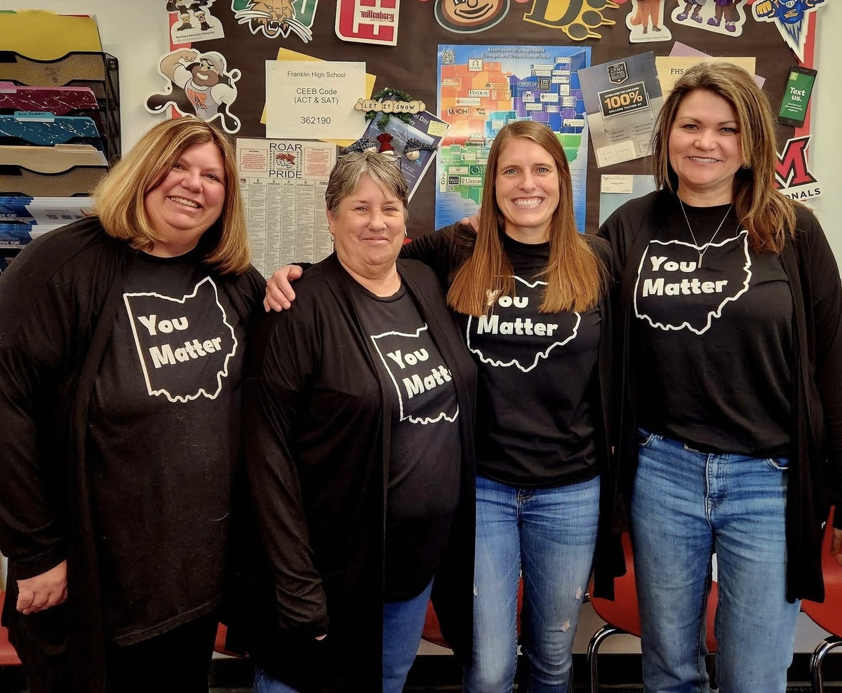 four people smiling for photo